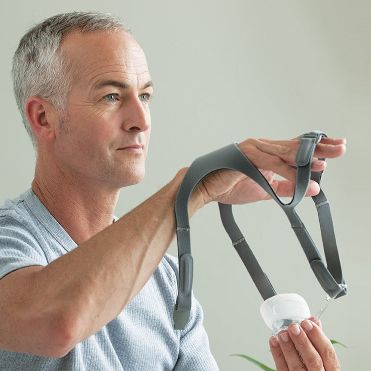 man putting on eson cpap mask headgear