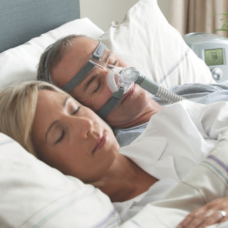 man in bed while wearing eson nasal cpap mask