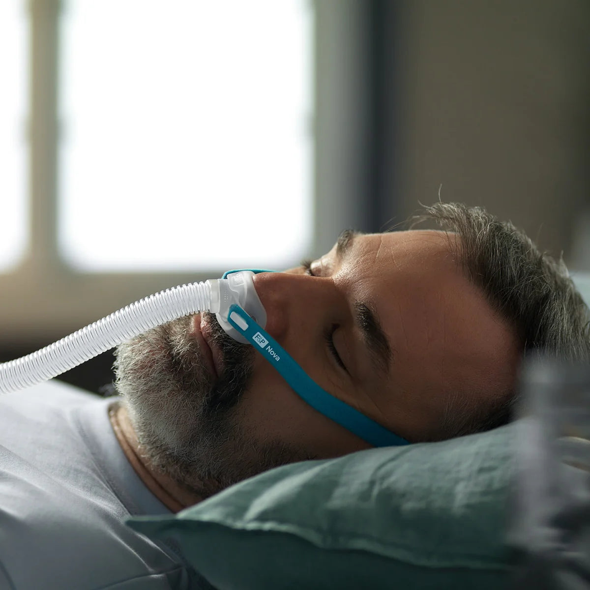 Man Sleeping with Nova Micro CPAP Mask