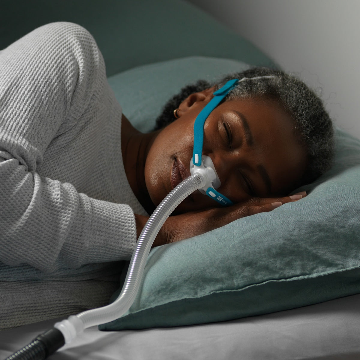 Lady Sleeping While Wearing a Nasal CPAP Mask