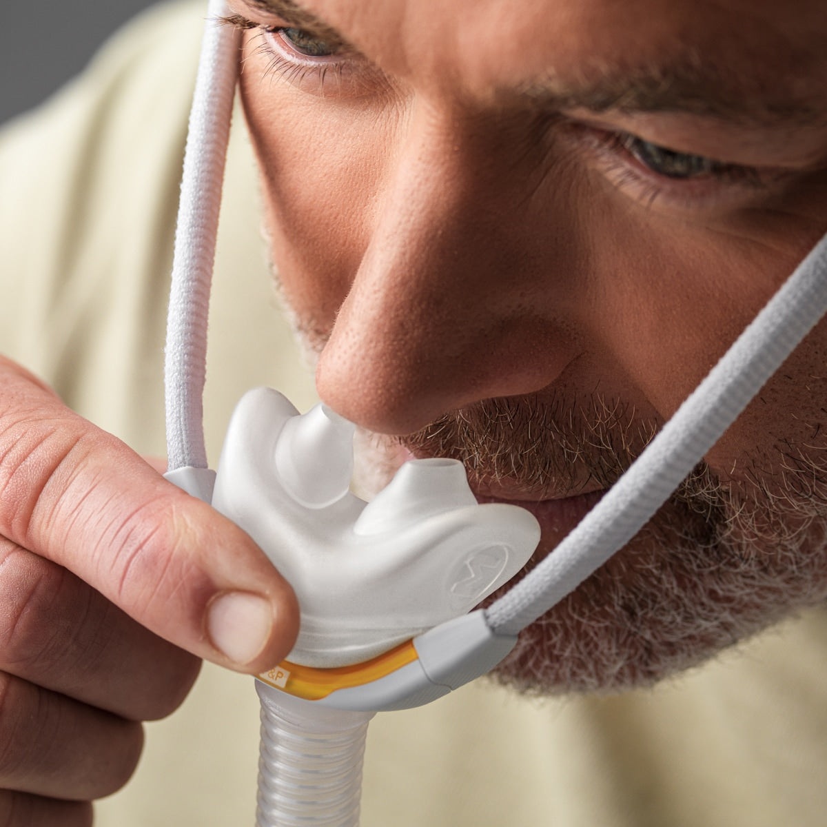 Man putting on Solo CPAP Mask