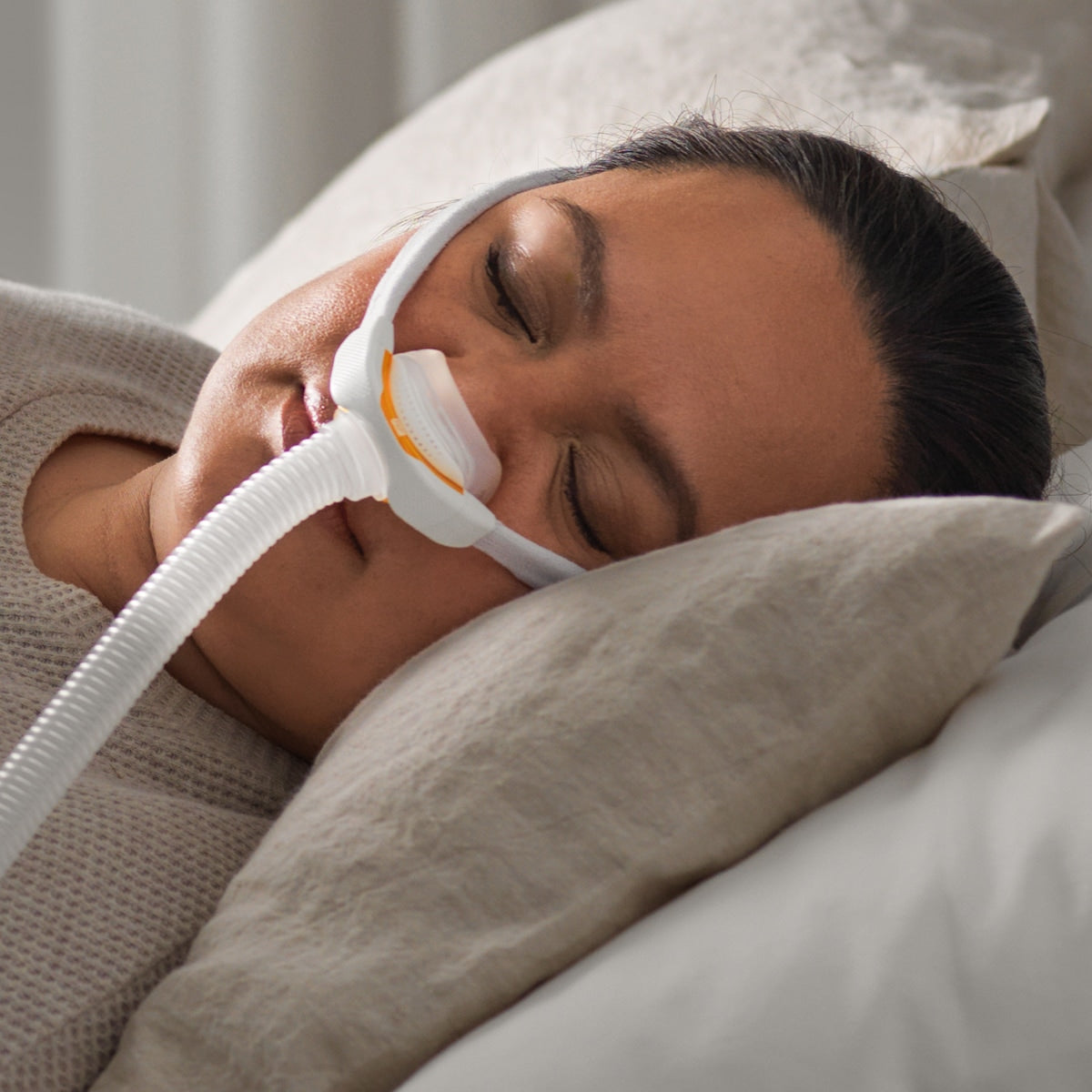 Woman Lying in Bed With CPAP Mask On