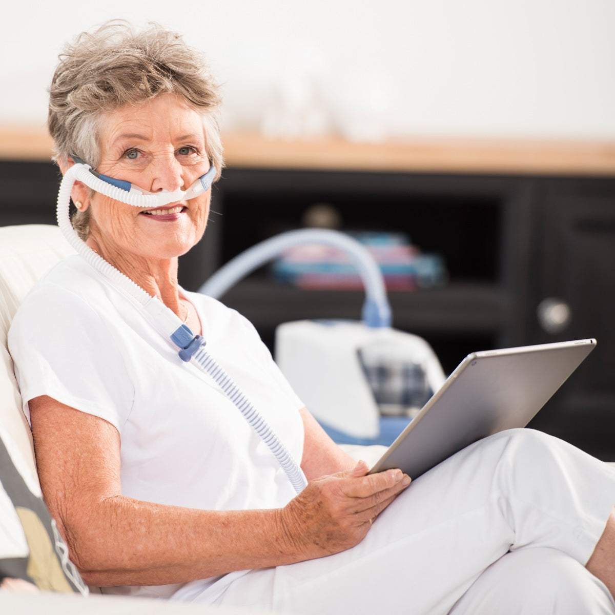 Woman Reading while wearing CPAP Mask