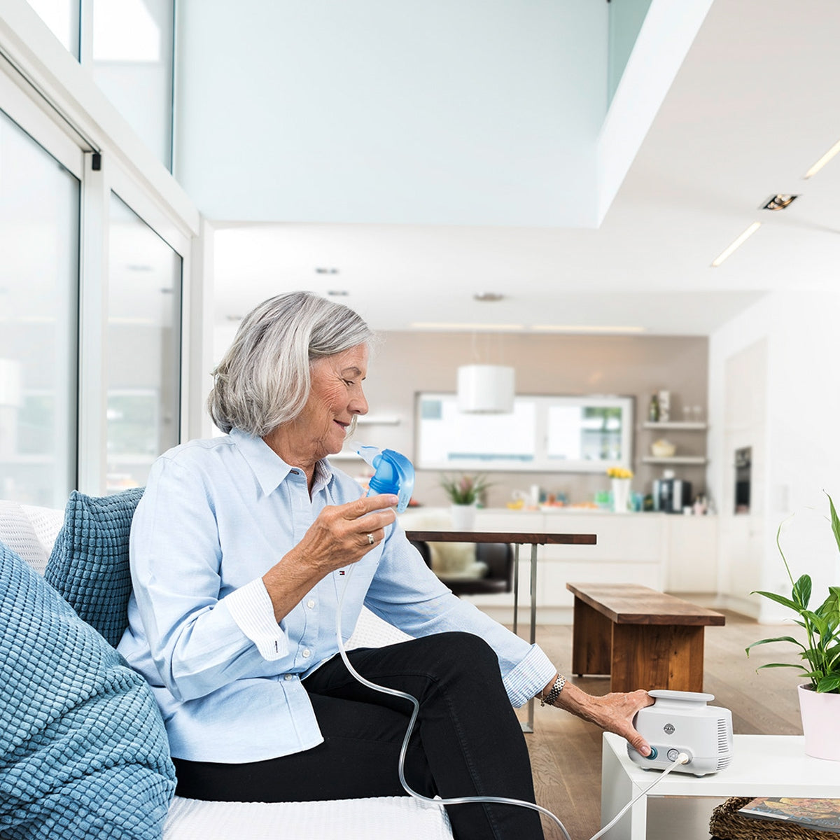 Lady Using a Nebulizer in a Home Setting