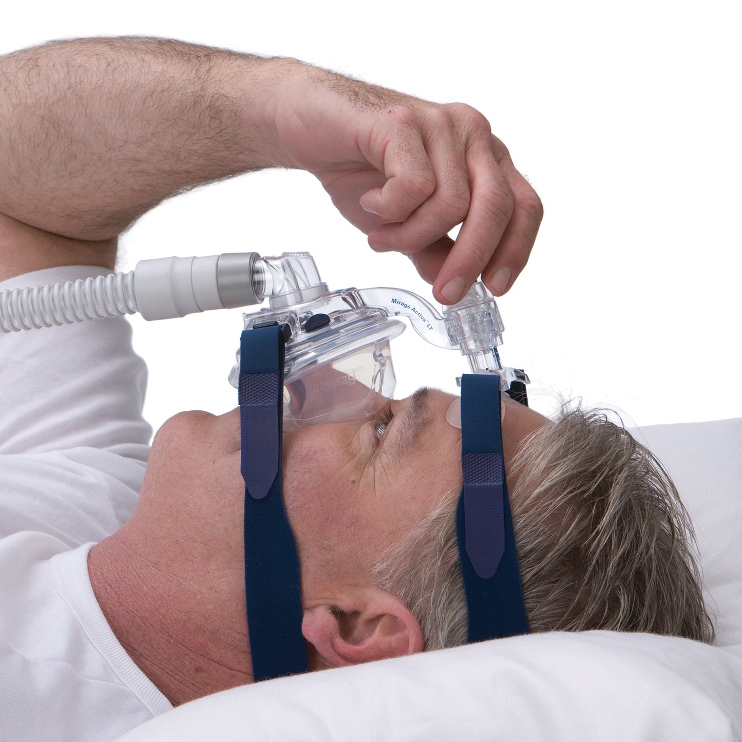 Person using a CPAP mask with a white background