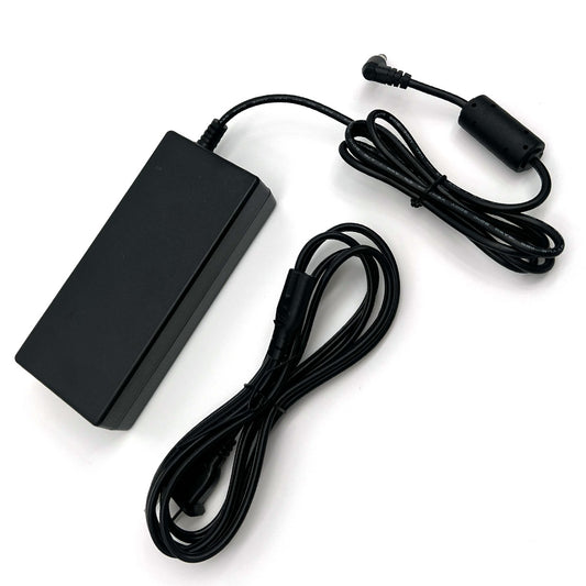 An AC power supply with a cord, black in color, designed for use with portable oxygen concentrators.
