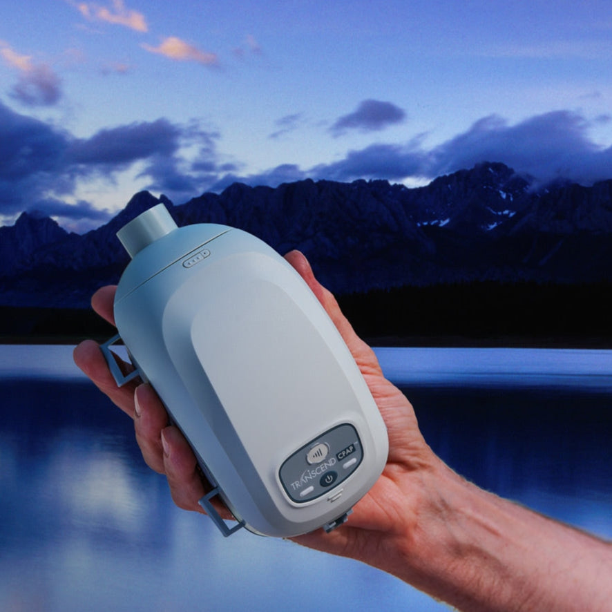 Person Outside Holding Transcend II Mini CPAP