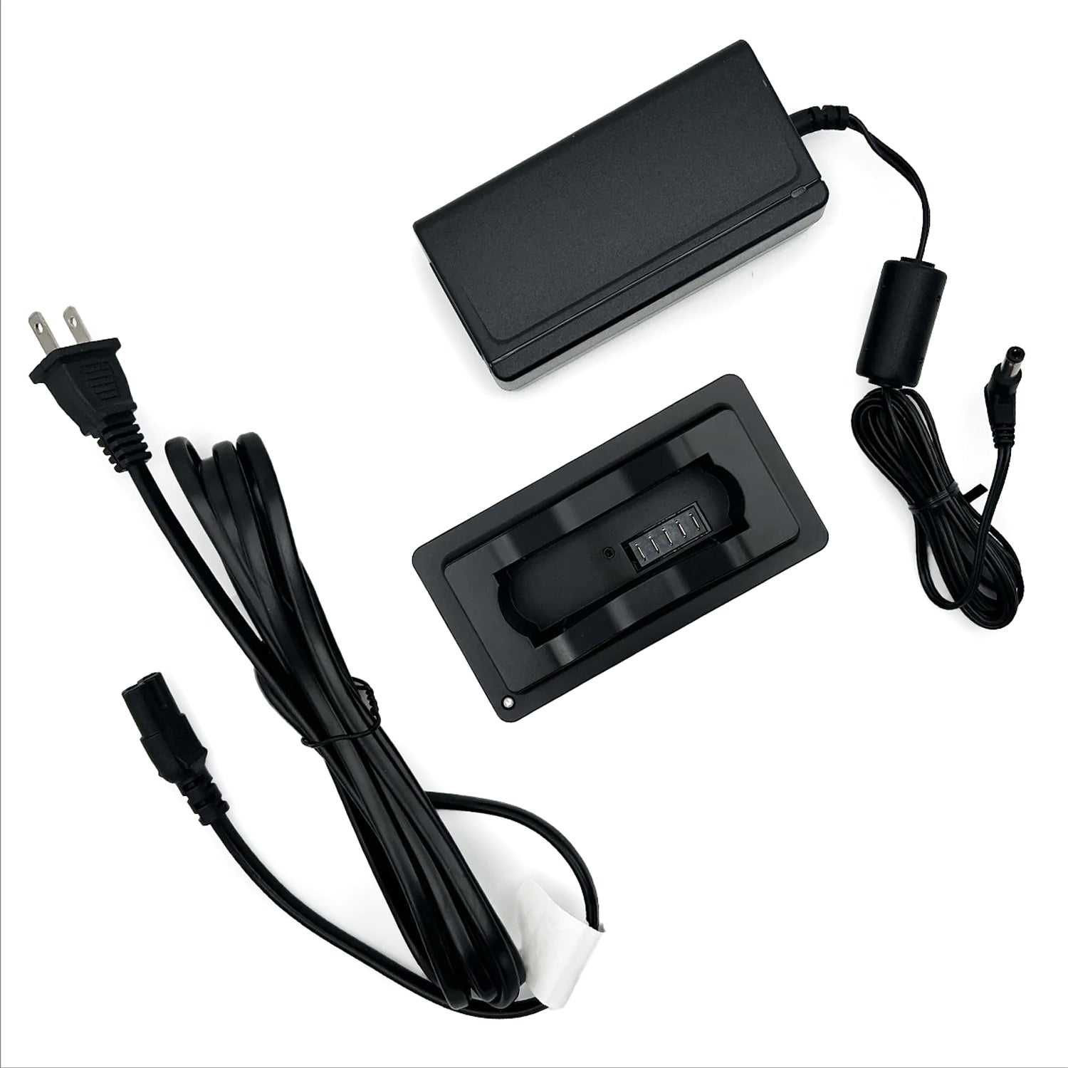 Black electronic components including a power adapter and cables on a white background
