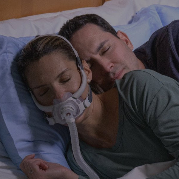 Couple Sleeping with Woman Wearing AirFit F40 CPAP Mask