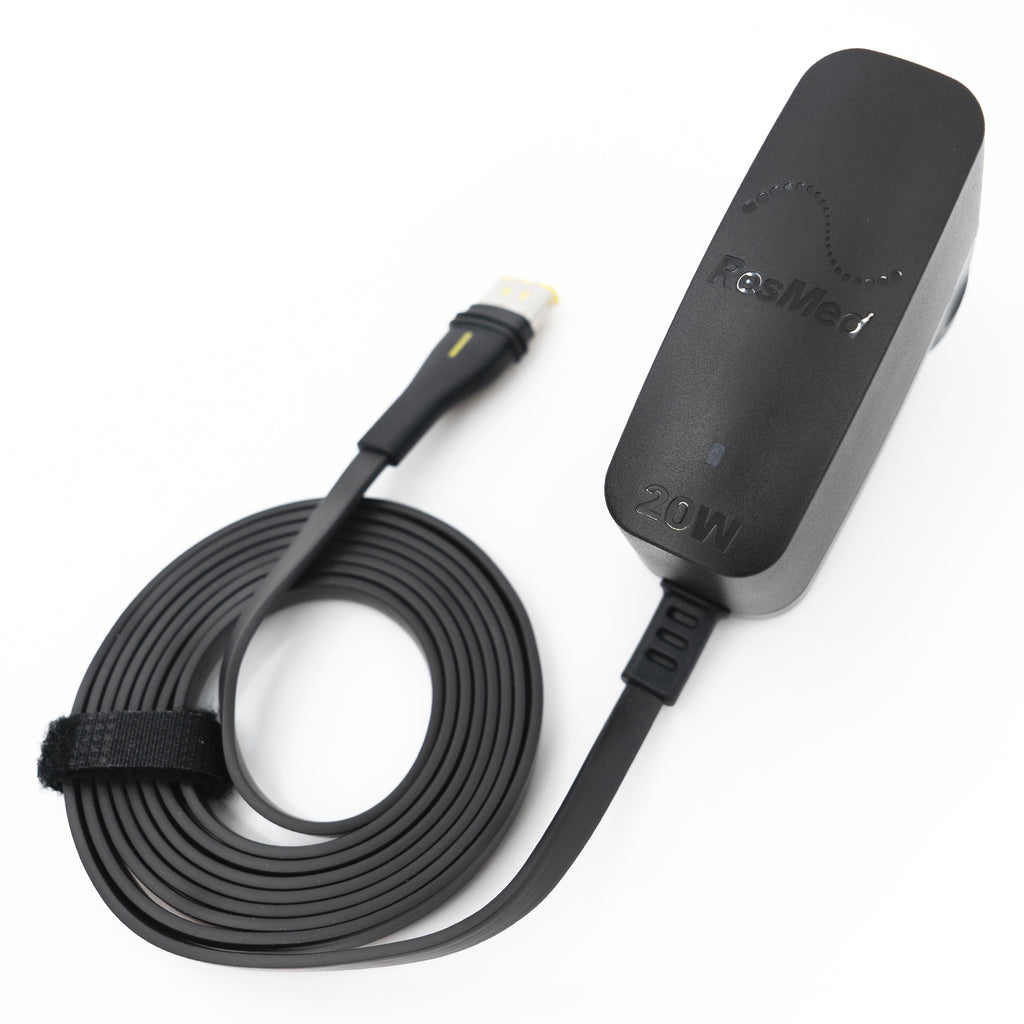 Black electronic device with cable on a white background