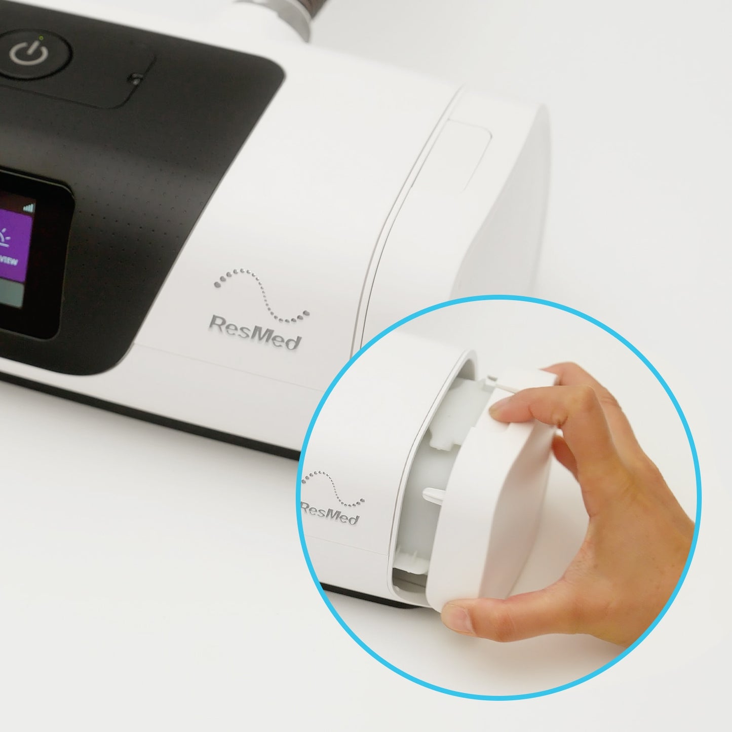 ResMed device with a hand holding a white component on a white background