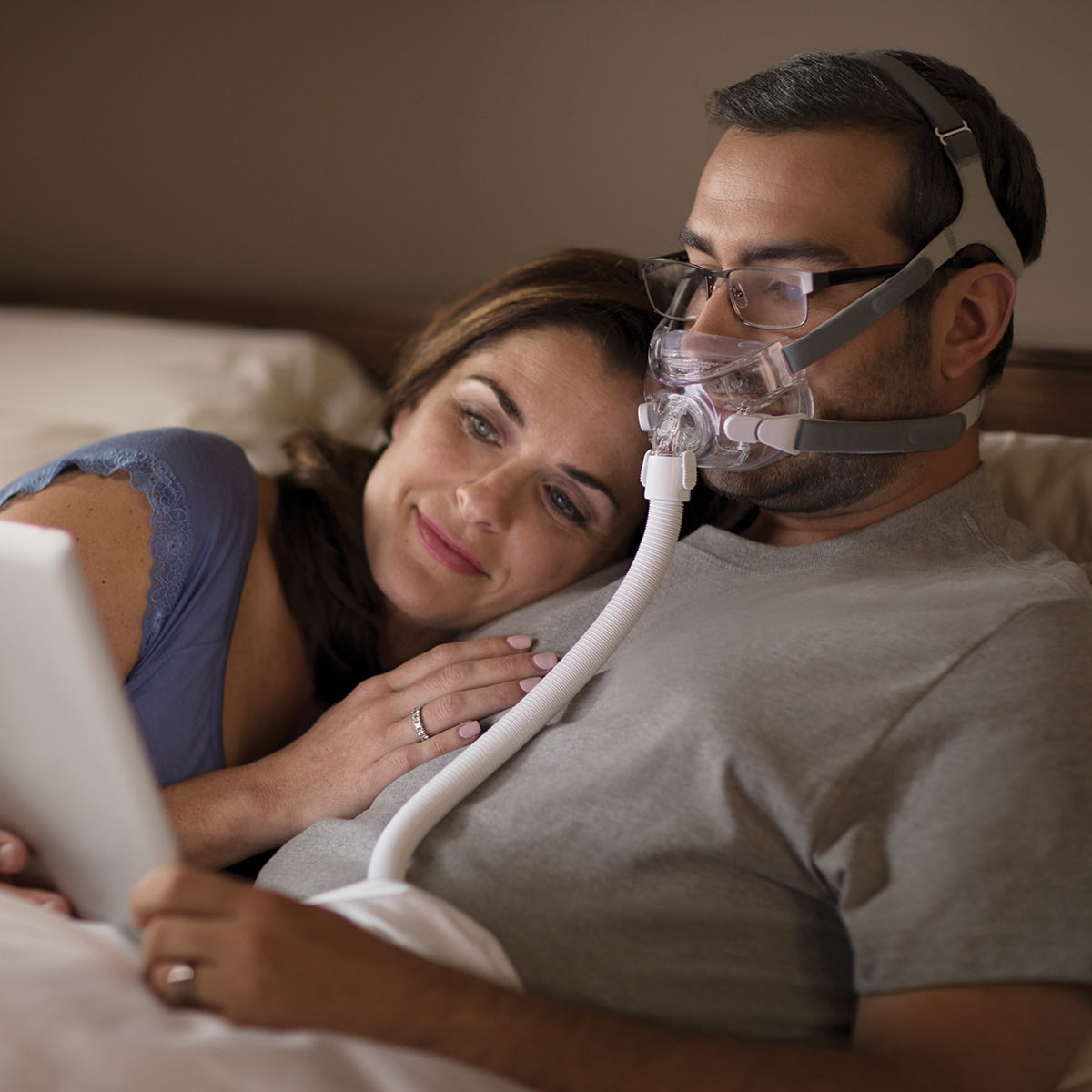Man Wearing Amara Mask in Bed While Reading 