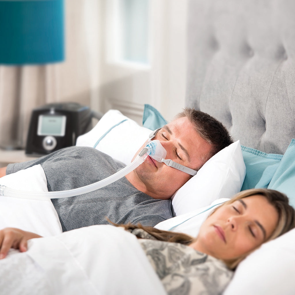Man In Bed Wearing Brevida Nasal Mask 