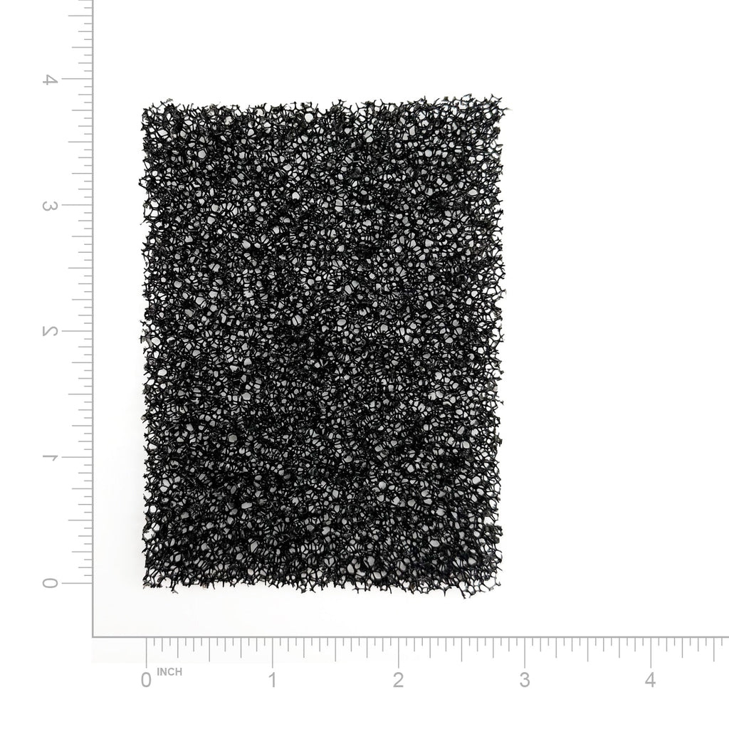 Textured black filter on a white background with measurement scale
