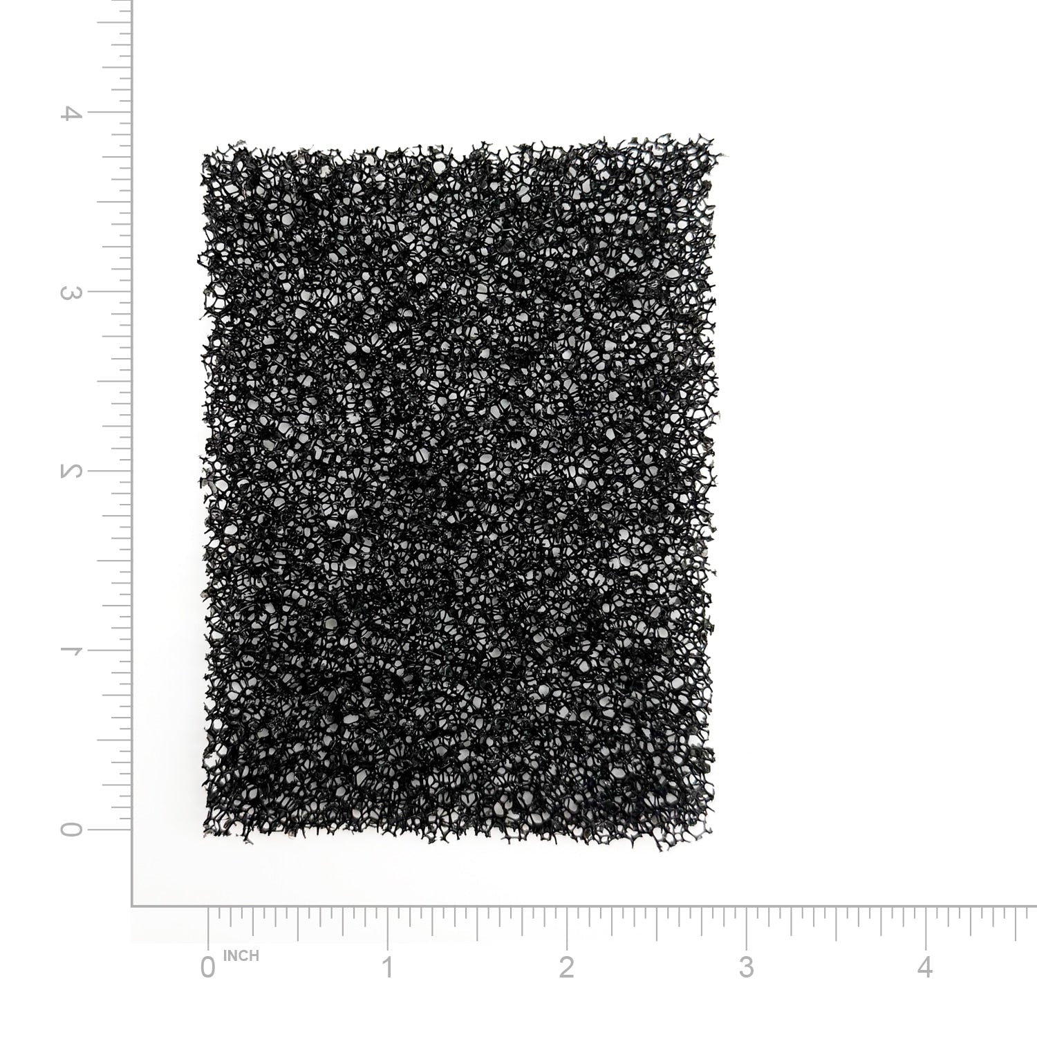 Textured black filter on a white background with measurement scale