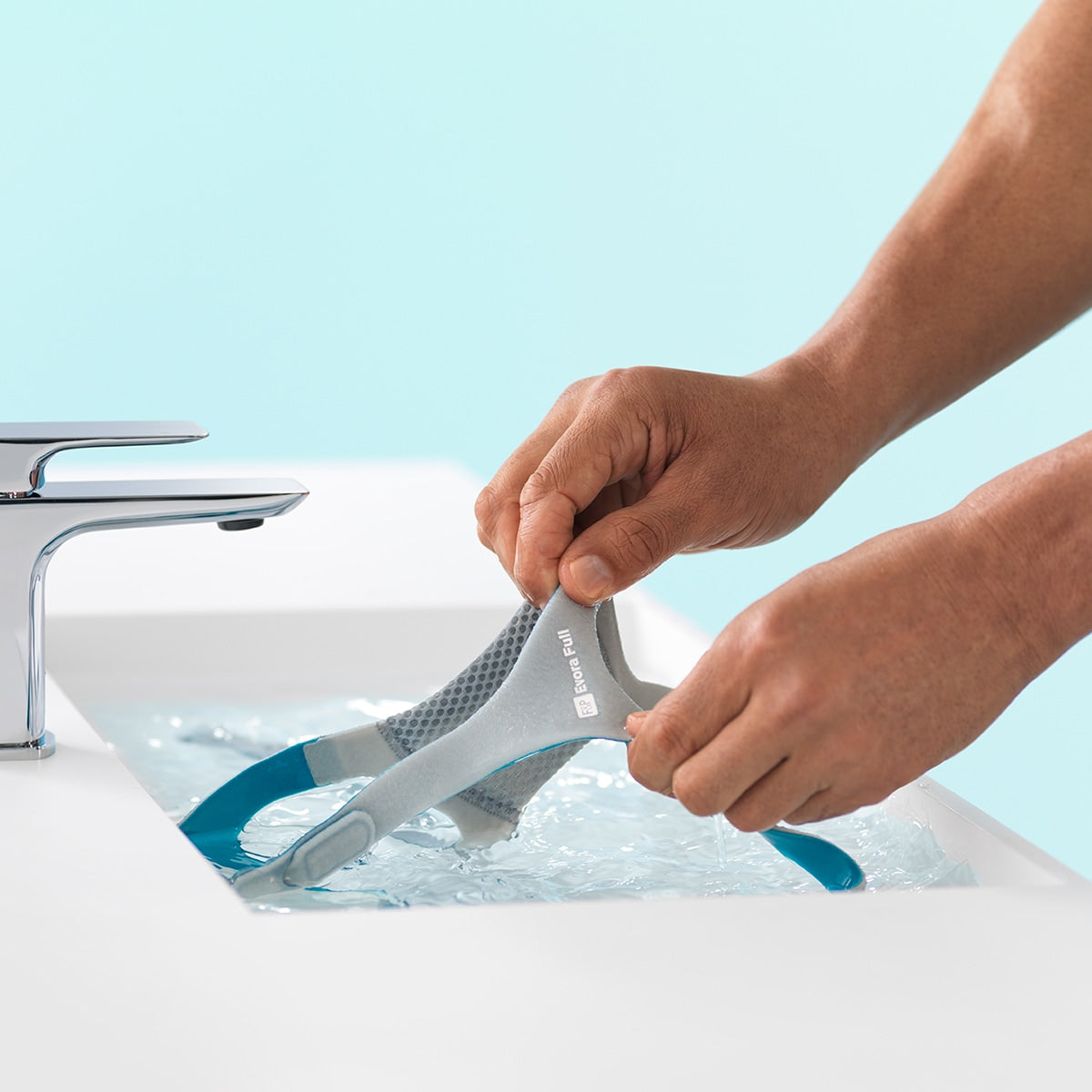 Hands in a Sink Washing a Evora Full Face Mask 