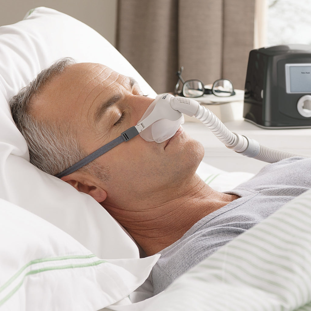 Man using a CPAP machine in bed