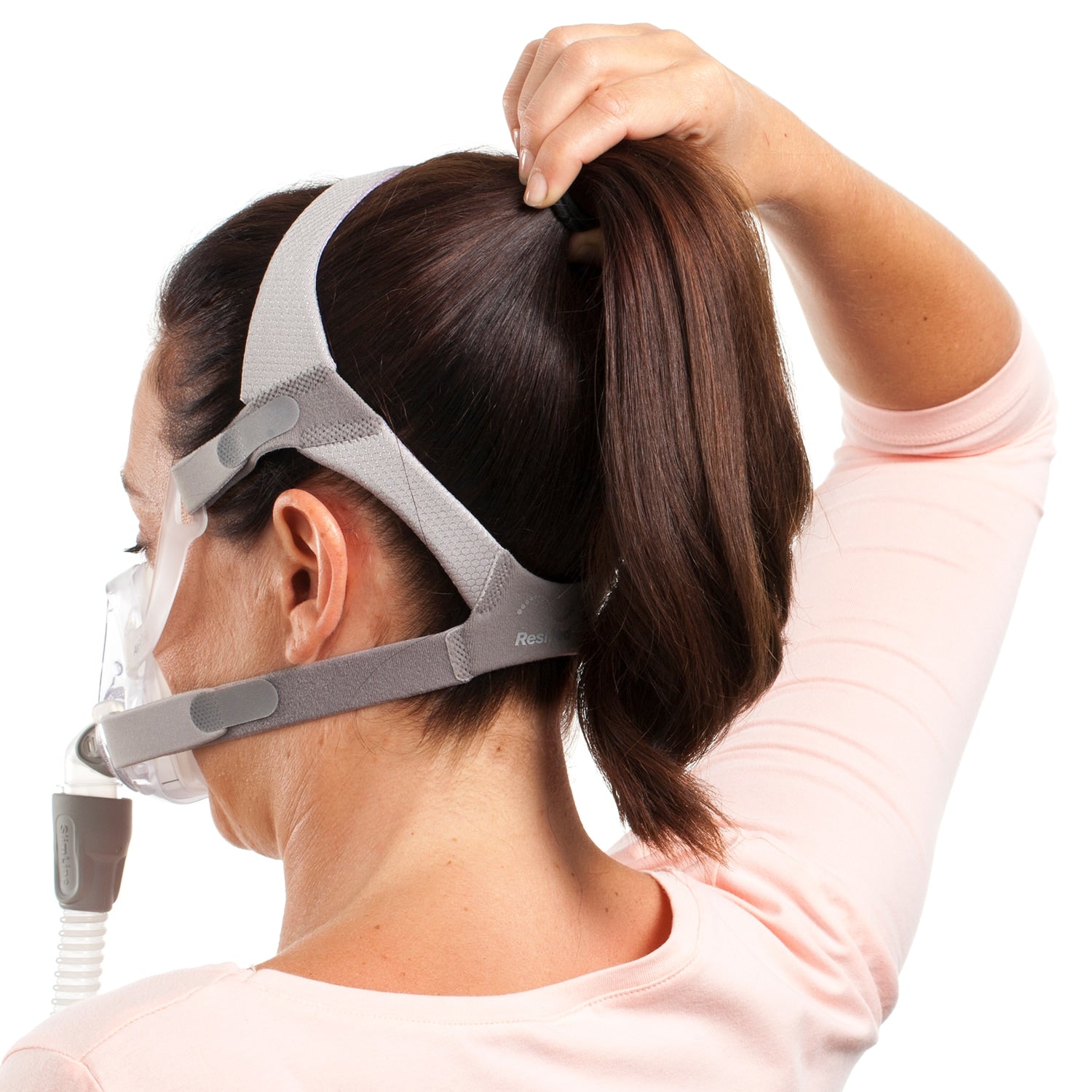 Person wearing a CPAP mask with a white background