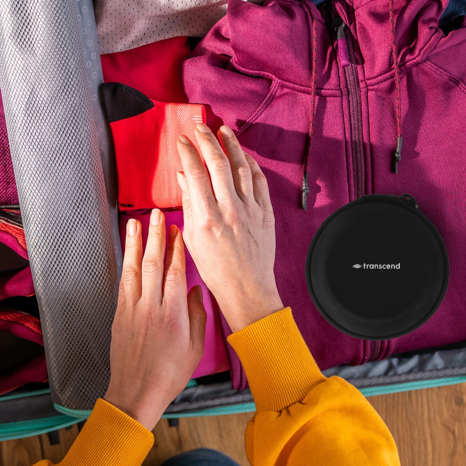 Person Packing a Transcend Micro Auto CPAP in a Hard Shell Case into a Suitcase 