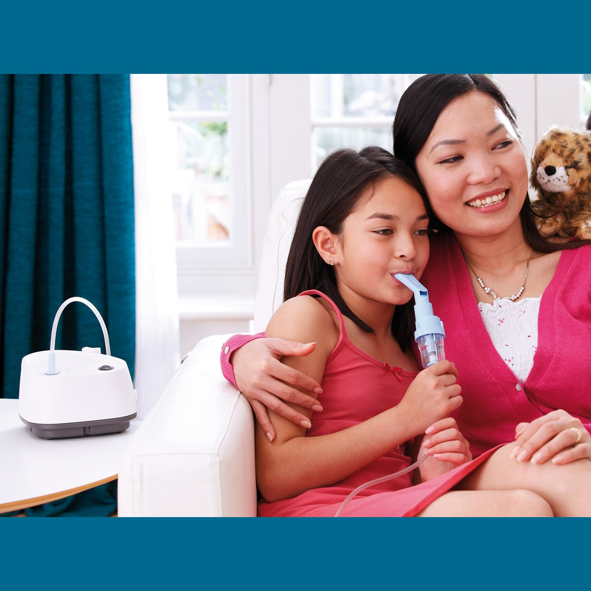 Child using an Inspire Elegance Compressor Nebulizer while sitting next to a woman
