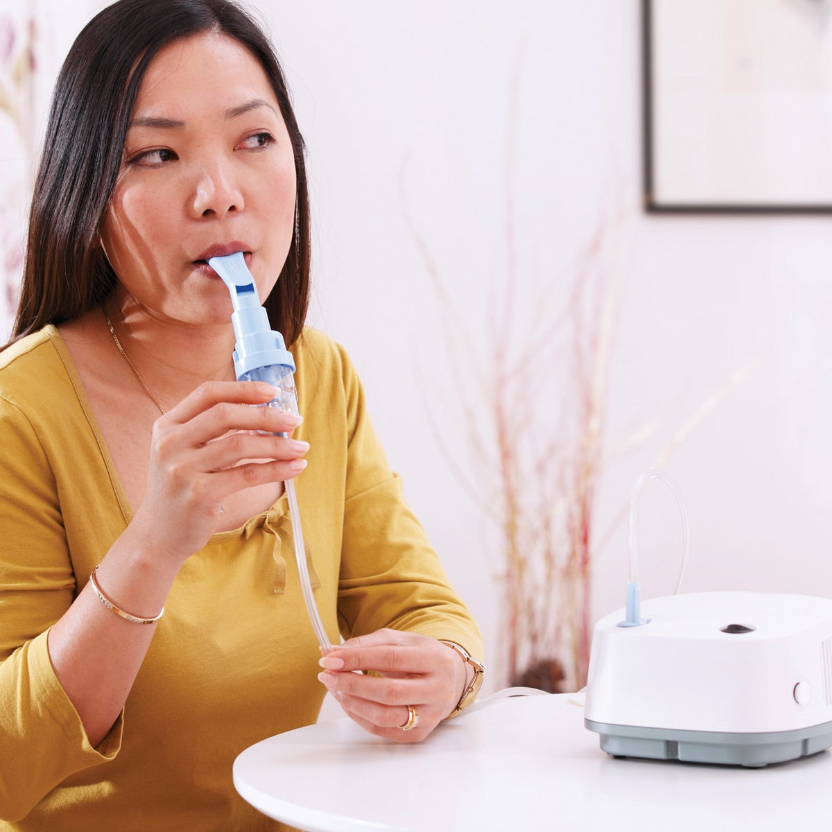 Woman Using an Inospire Essence Compressor 
