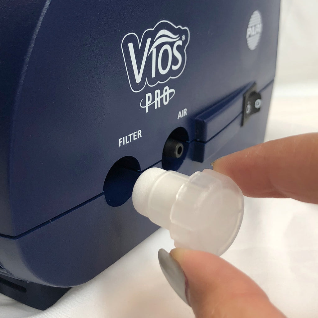 Vios Pro device with a hand holding a white filter and holder