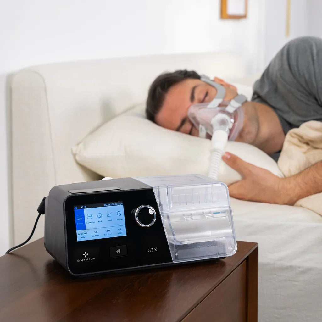 Man Sleeping with CPAP mask on with a Luna G3X CPAP Machine on a side table 