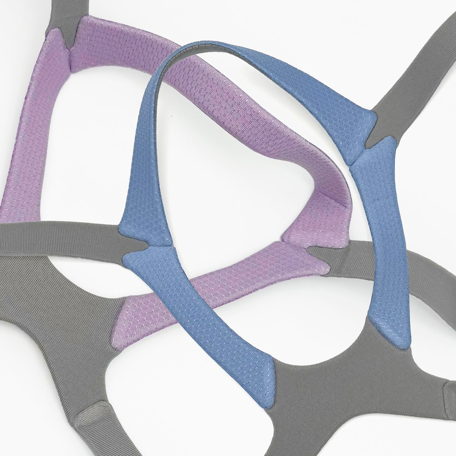 Close-up of a pink, blue, and gray mesh headgear on a white background