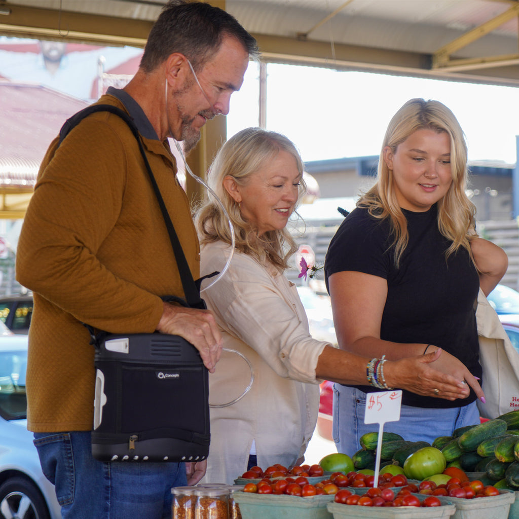 Man at Vegetable Stand while wearing Oxlife Portable Oxygen Concentrator 