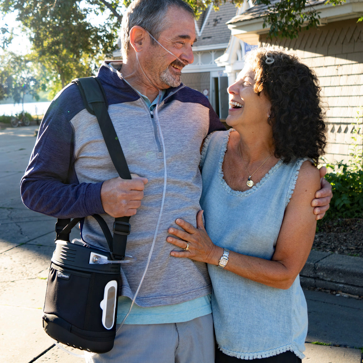 Man Hugging Woman while wearing Oxlife Liberty Portable Oxygen Concentrator 