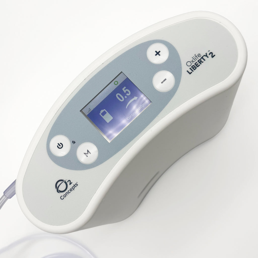 Concepts Liberty 2 oxygen concentrator  in white and light gray, featuring a digital display screen and four control buttons.