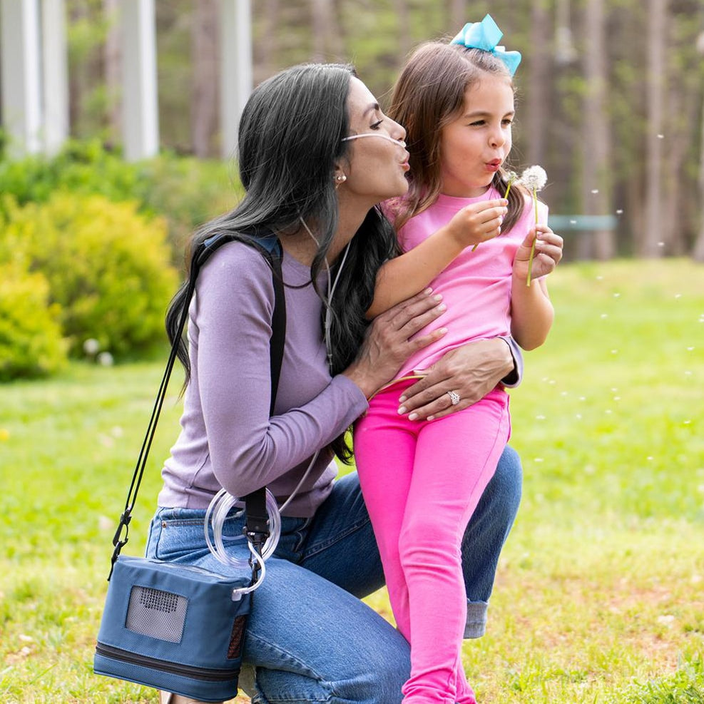 Lady using Oxygen Concentrator with Child 