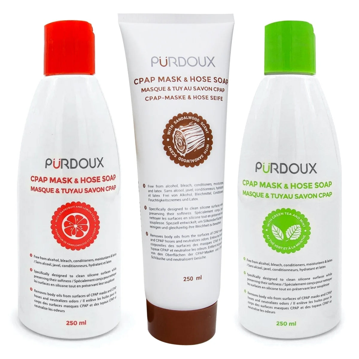 Three bottles of Purdoux CPAP mask and hose soap with different colored caps on a white background.