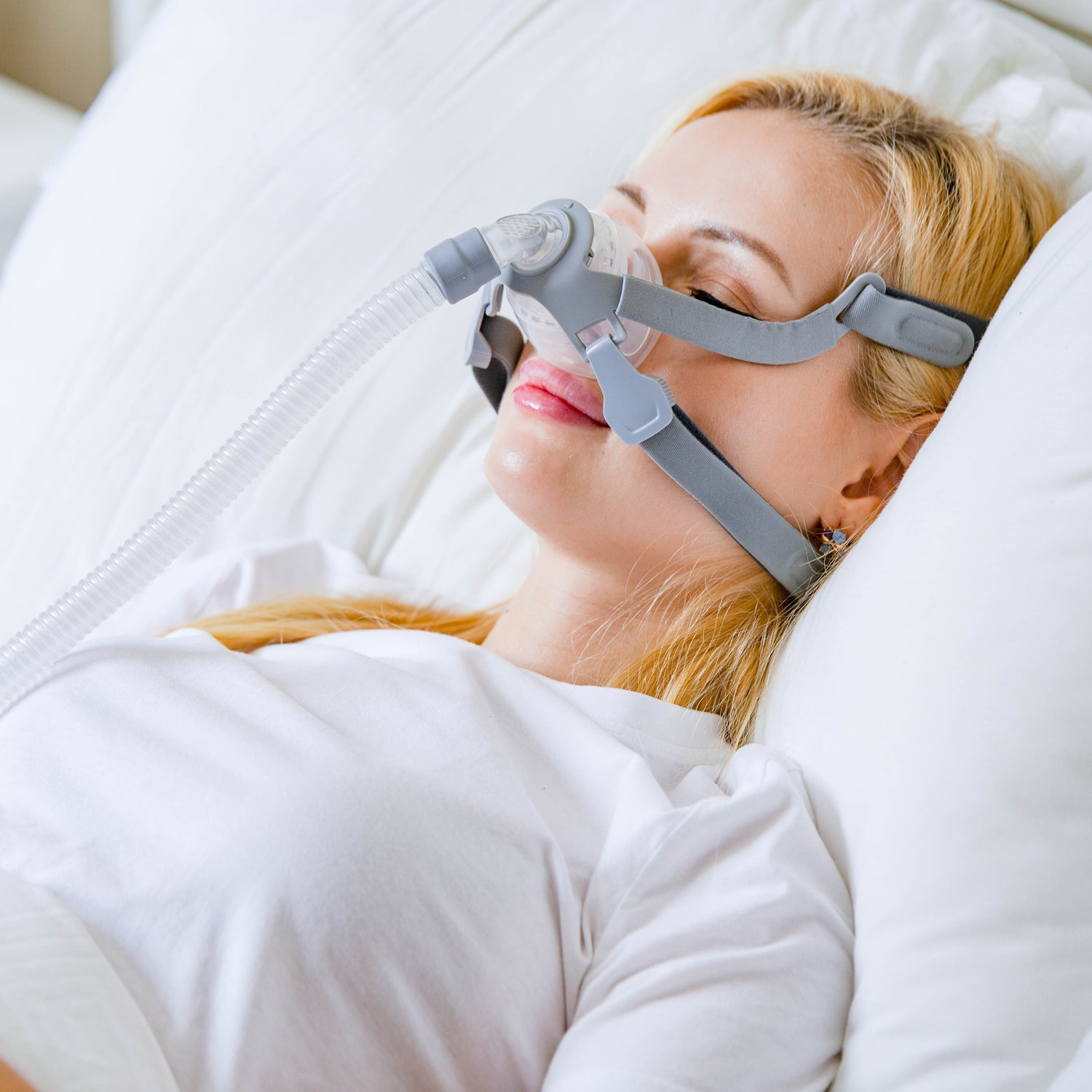 Woman wearing a CPAP mask while sleeping