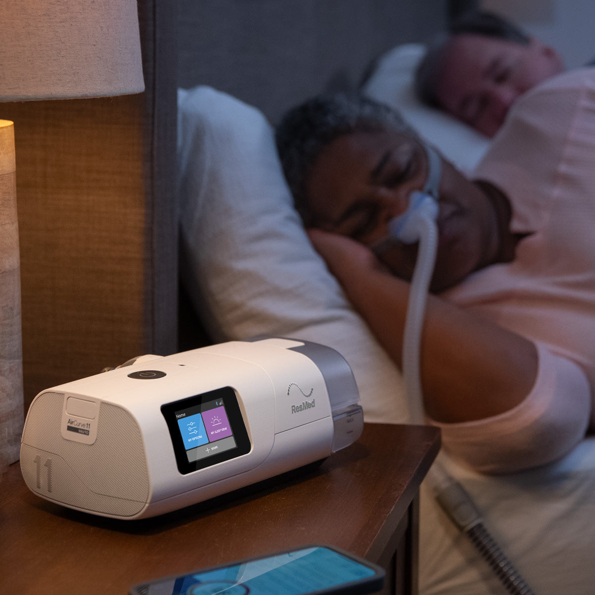 woman sleeping while wearing a p10 mask and using an aircurve 11 bilevel machine