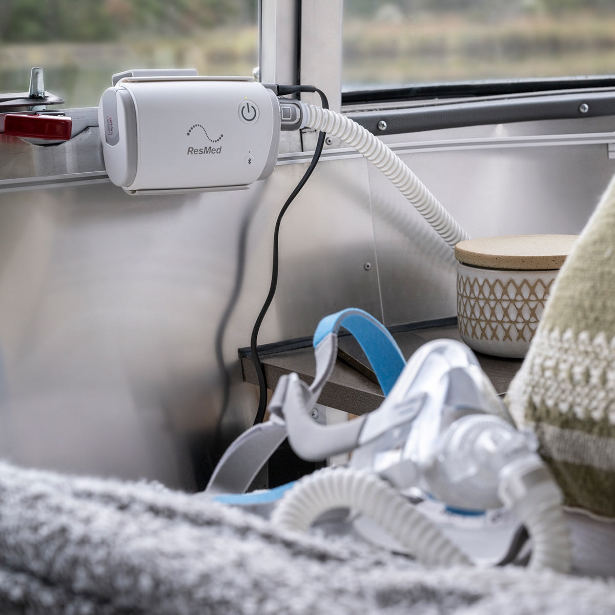 AirMini CPAP Mounted on Wall Inside a Family's Camping Trailer