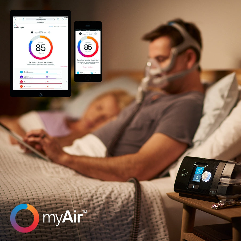man in bed with an airsense 10 cpap looking at myair therapy app
