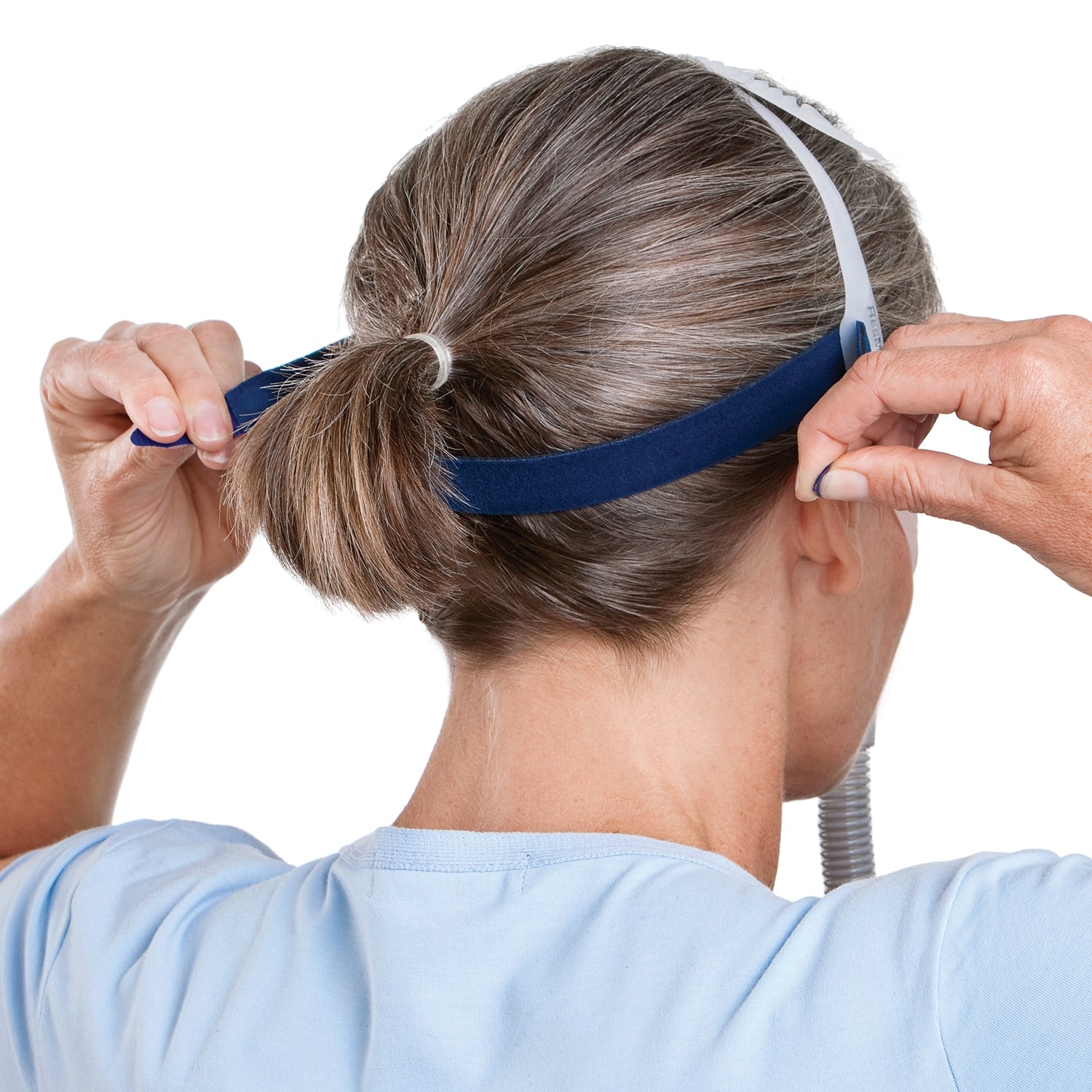 Person adjusting a blue headband with a white background