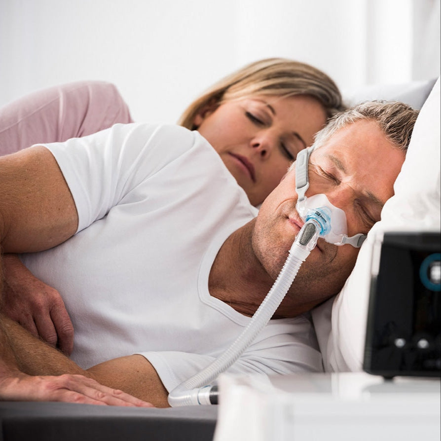 Man in Bed with a Brevida Nasal Mask On 