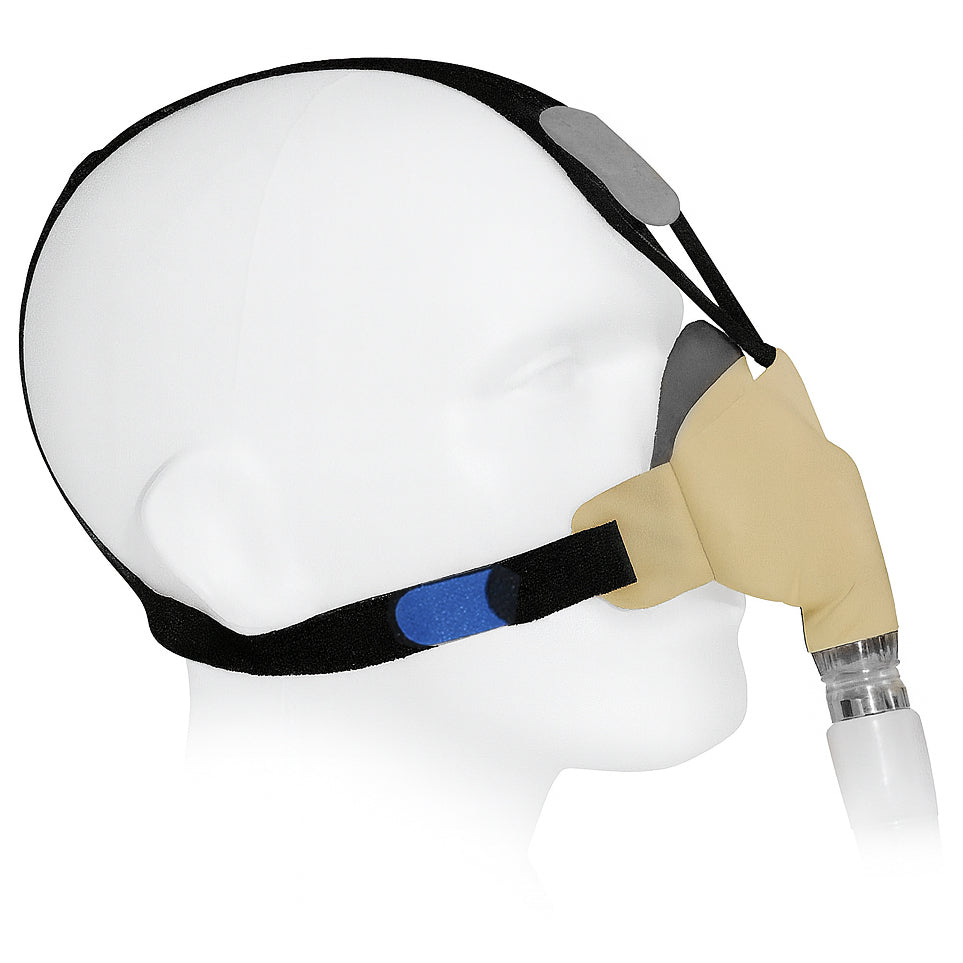 Headgear with tan cushion on a mannequin head with a white background