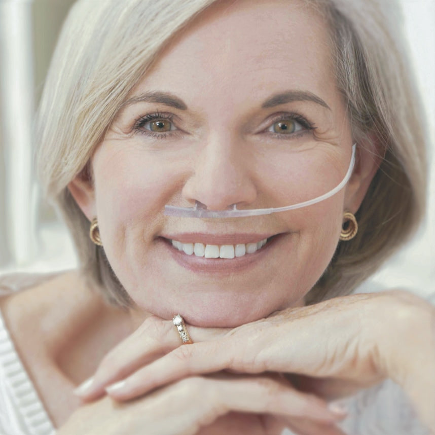 Woman wearing an Oxy-Breather oxygen cannula with a neutral background
