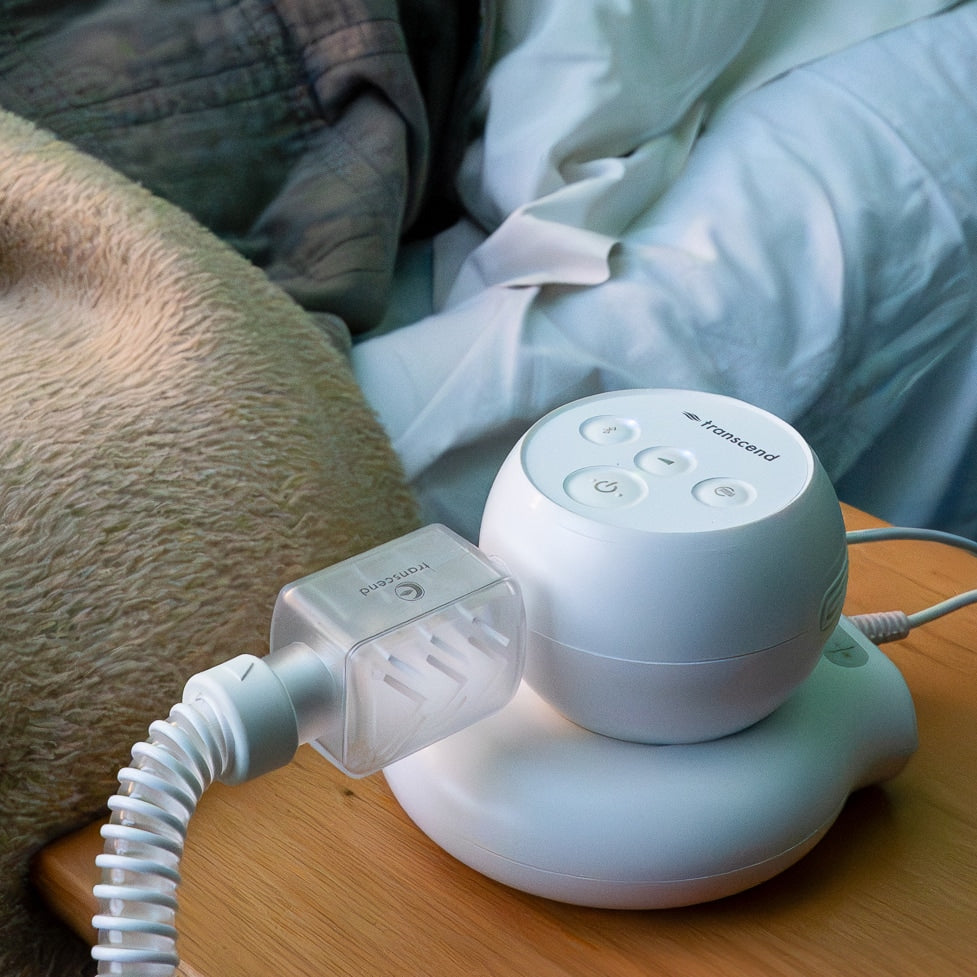 Transcend CPAP Machine with battery next to bed.