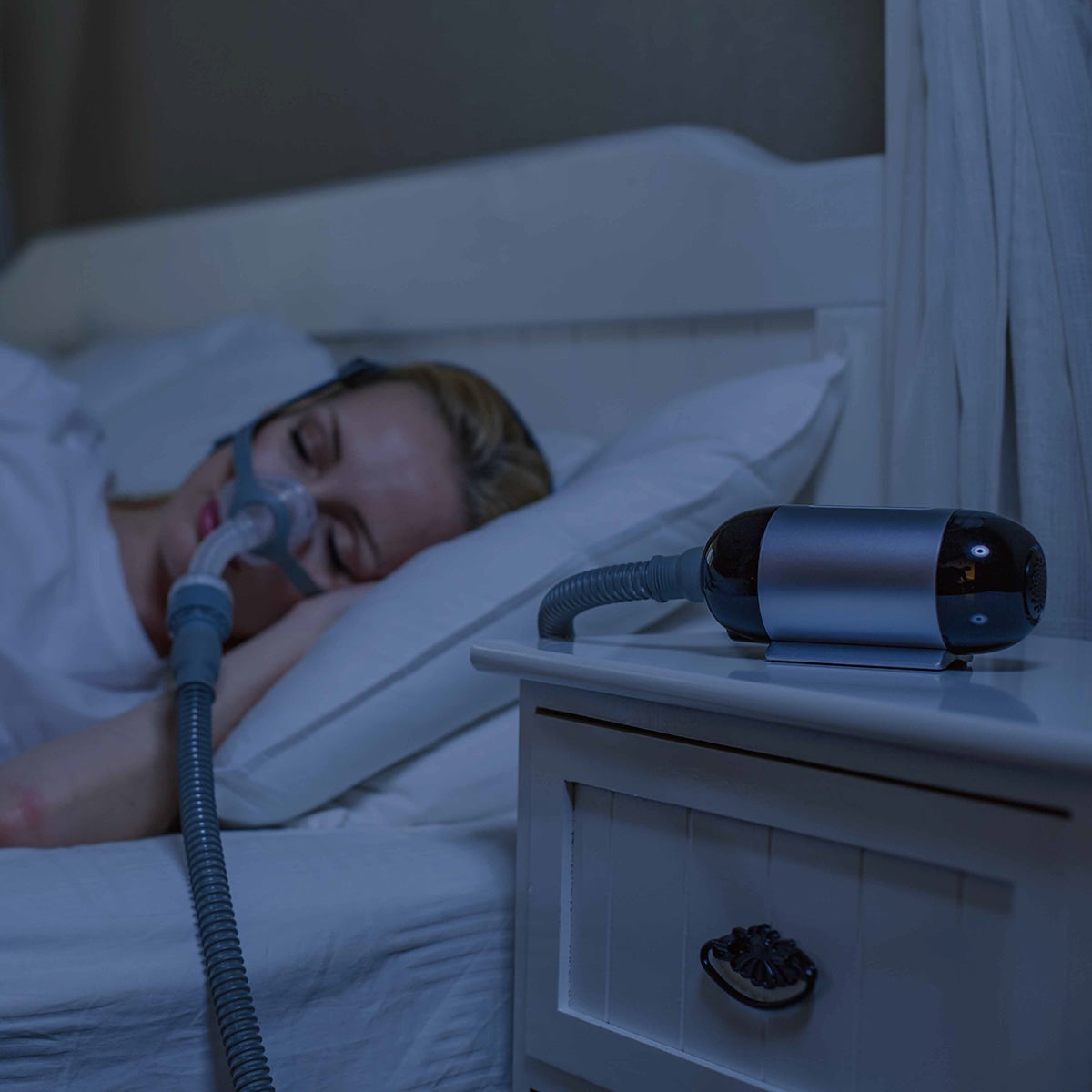 Women in Bed with Luna Travel CPAP Machine on Night Stand