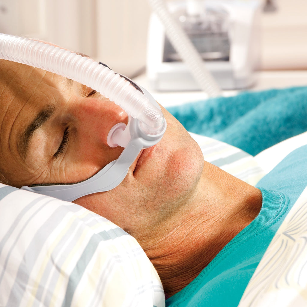 Closeup of person in bed wearing an Opus 360 cpap mask