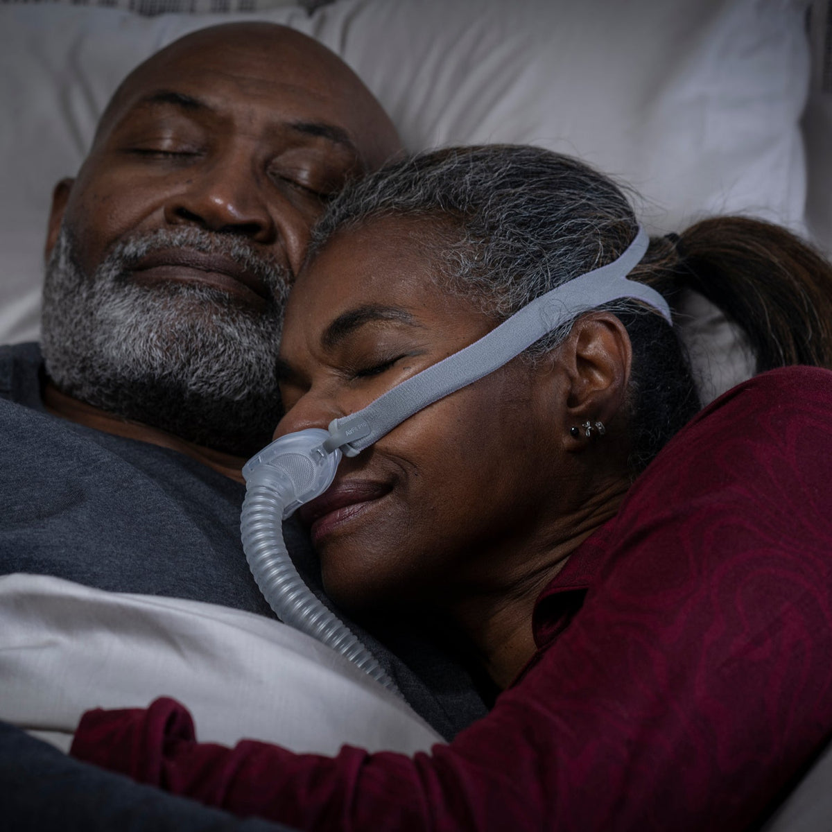 Man sleeping with an Airlift P10 Nasal Pillow CPAP mask