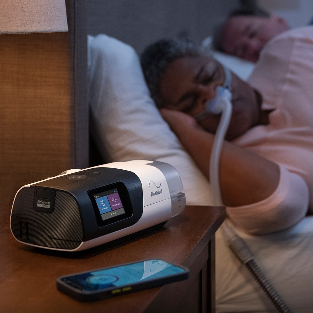 woman sleeping while wearing a p10 cpap mask and using an airsense 11 autoset machine