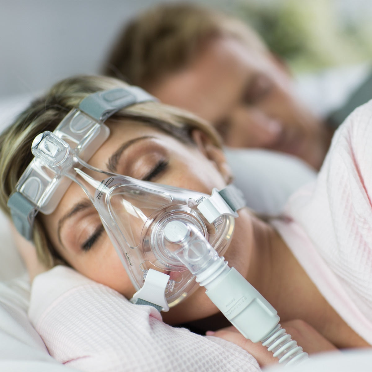 Woman In Bed Wearing Amara CPAP Mask 