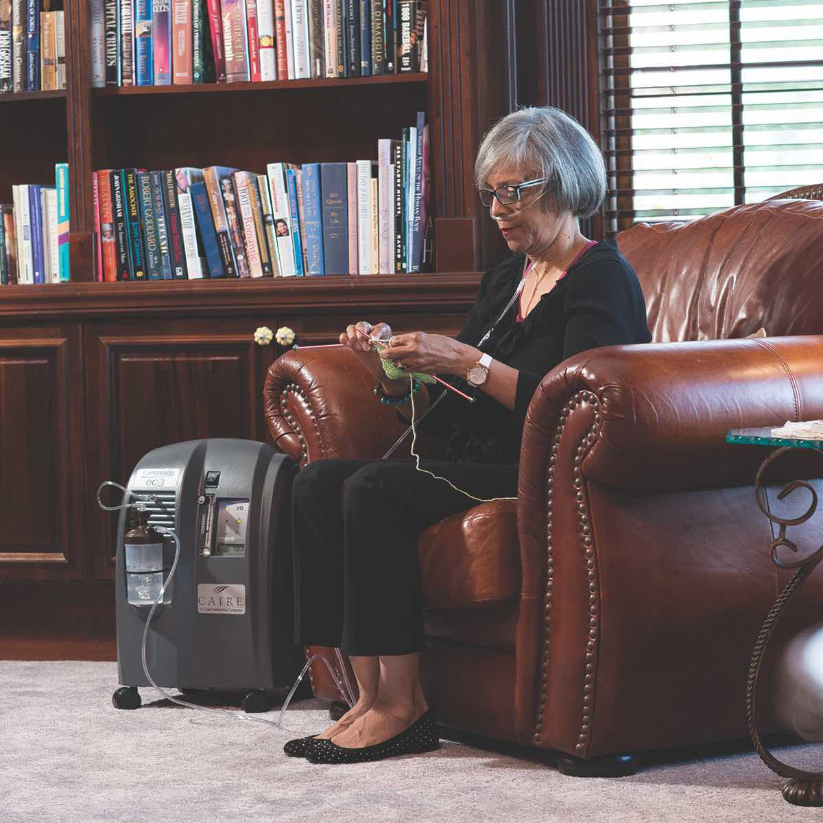 Woman Sitting in chair knitting wearing Companion Concentrator 