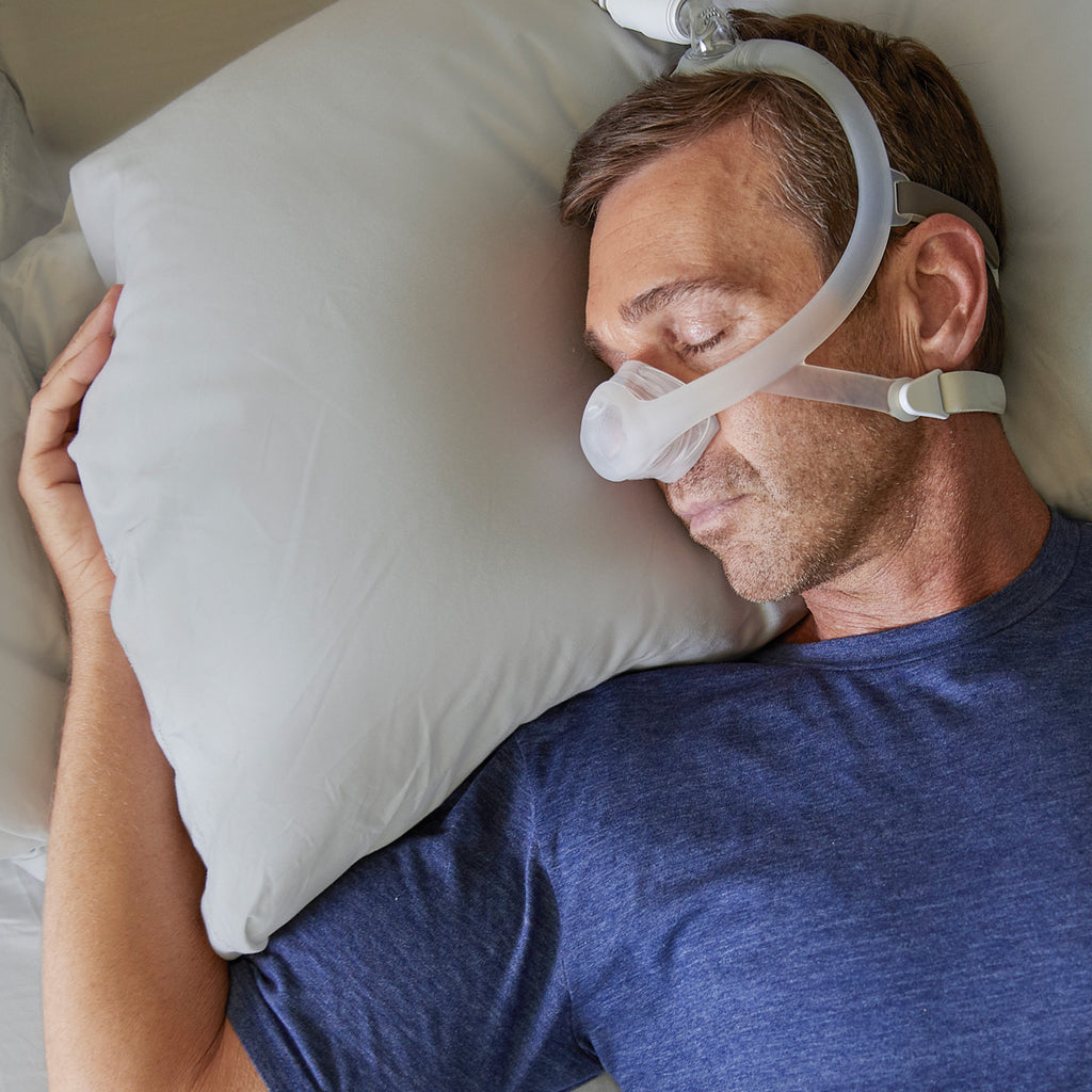 Man sleeping while wearing a Dreamwisp CPAP Mask 