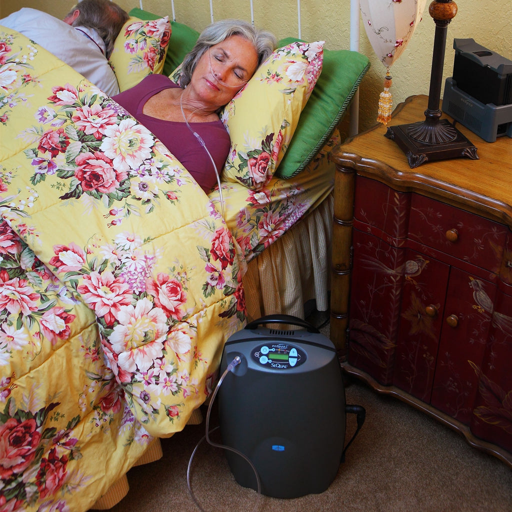 A Woman Sleeping in bed while using an Eclipse Portable Oxygen Concentrator 